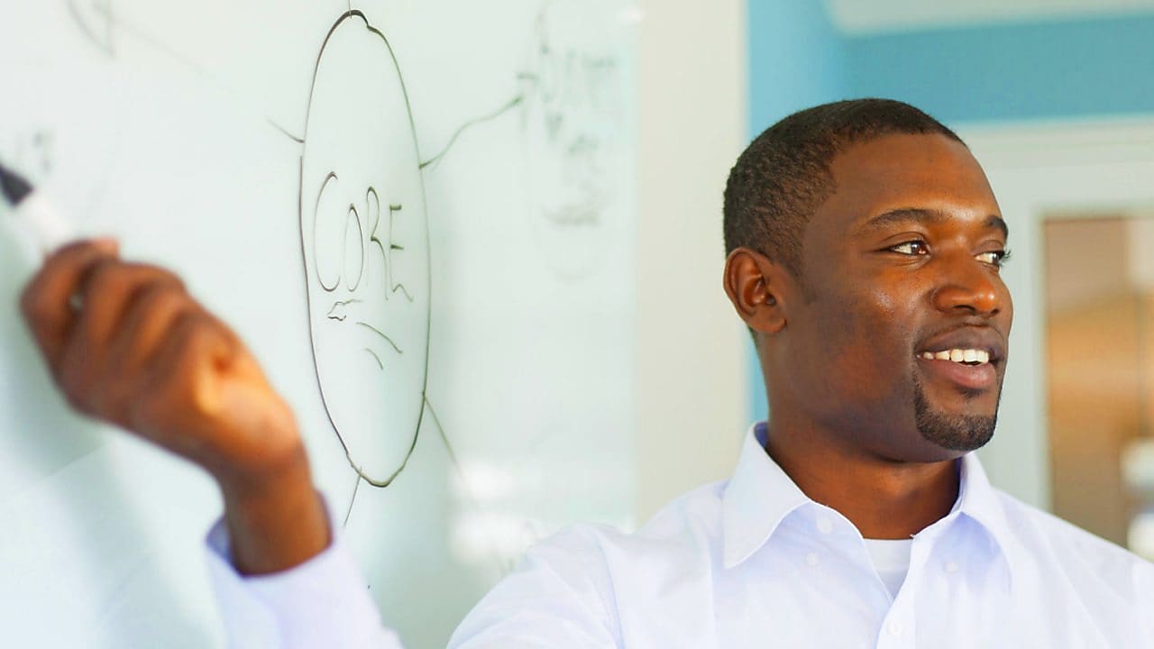 Young professor in front of a whiteboard