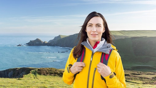 Woman standing in the mountain with bags