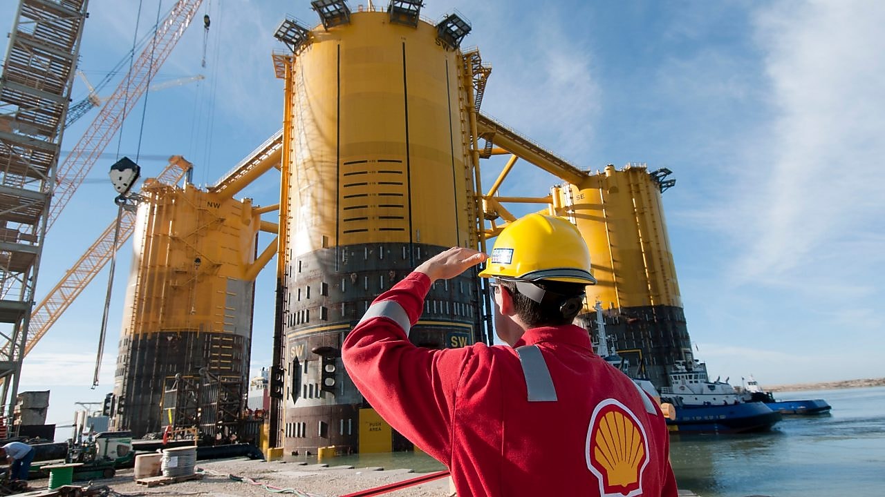 Engineer looking up at platform under construction