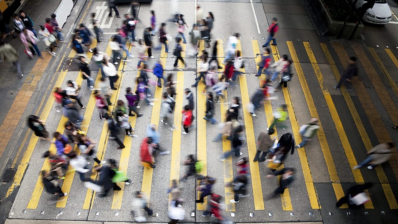 People crossing a busy street in Hong Kong