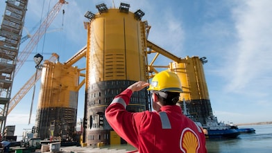 Engineer looking up at platform under construction