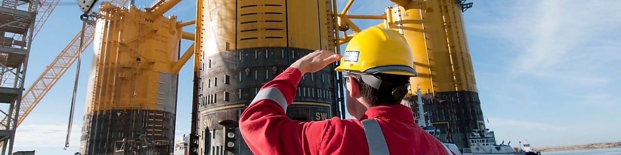 Engineer looking up at platform under construction