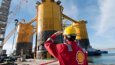 Engineer looking up at platform under construction