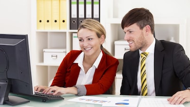 two colleagues looking at a computer screen