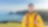Young man standing on cliff side overlooking a calm sea