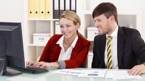 two colleagues looking at a computer screen
