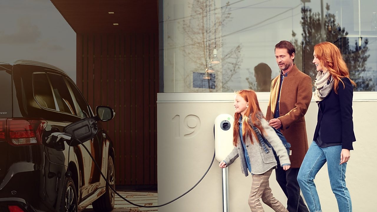 Photo of woman charging her EV