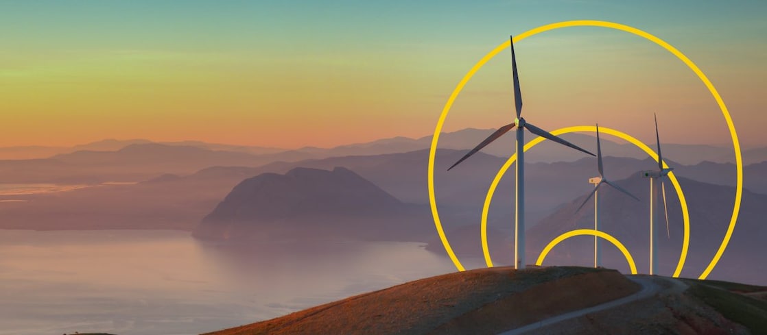Photo of three wind turbines on a hill with an outline of the Achieving net-zero emissions graph