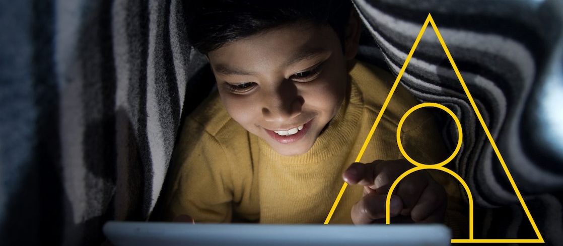 Photo of young boy looking at a tablet with an outline of the Powering lives graph