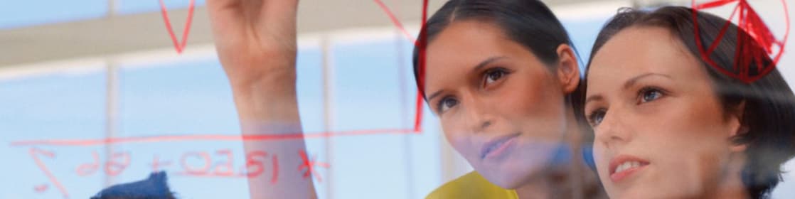 Businesswoman drawing graphs on glass