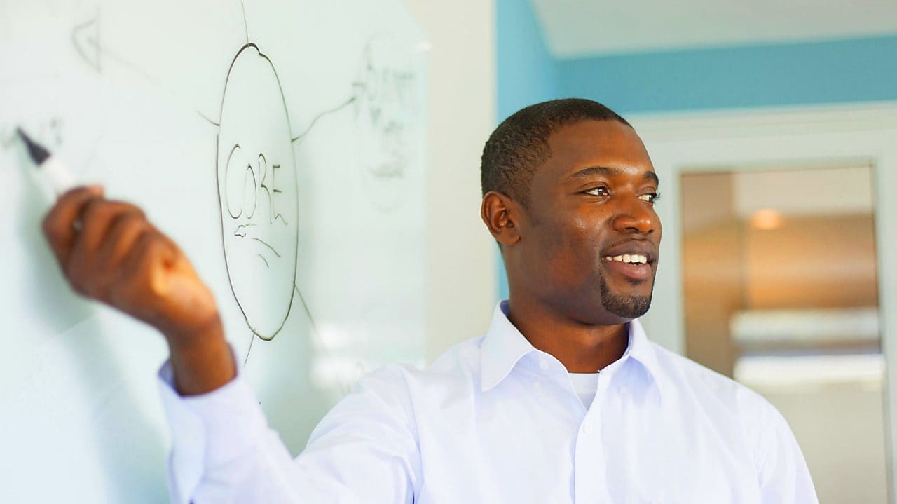 Young professor in front of a whiteboard