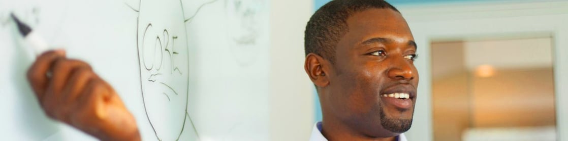Young professor in front of a whiteboard